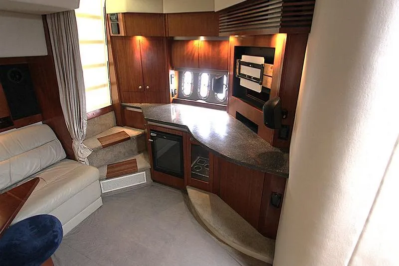Slide: The Image of Luxurious interior of a 2007 Cruisers 420 yacht with modern kitchen and seating area. - 13