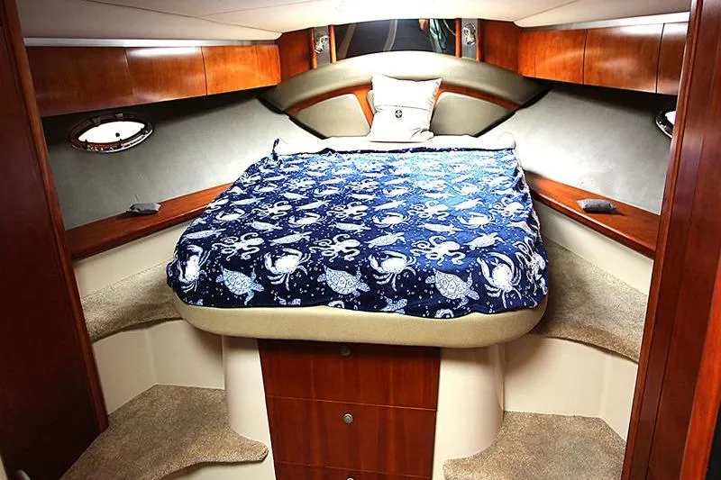 Slide: The Image of Luxurious 2007 Cruisers 420 yacht cabin with nautical-themed bedding and elegant wood finishes. - 14