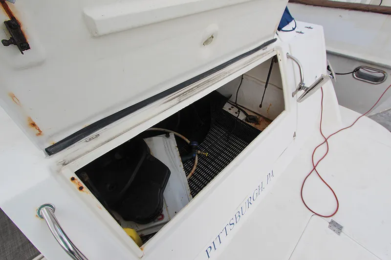 Slide: The Image of Open storage compartment on 2007 Cruisers 420 boat, showing interior details and rust spots. - 17