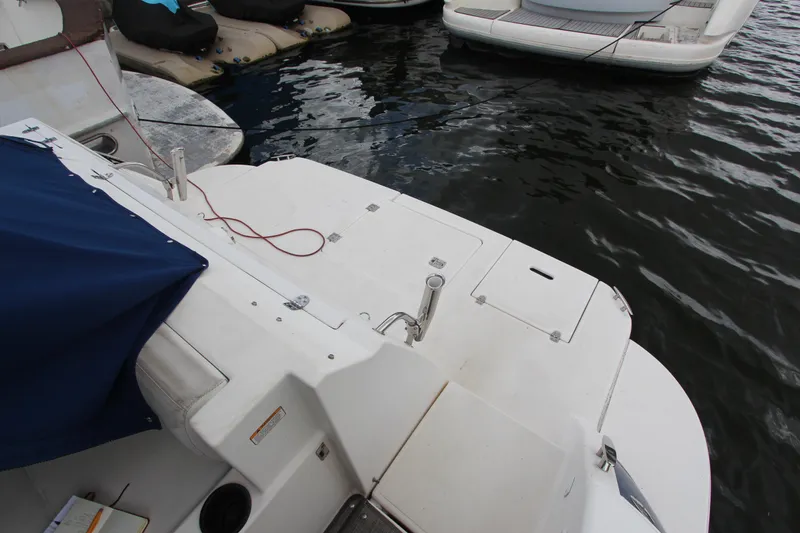 Slide: The Image of 2007 Cruisers 420 yacht stern view with docked boats in marina. - 2