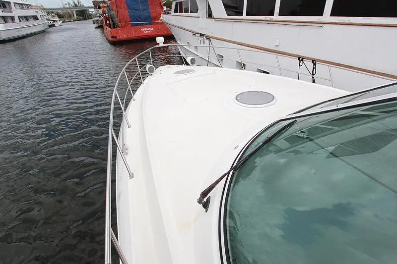 Slide: The Image of 2007 Cruisers 420 yacht docked in a marina, showcasing sleek white deck design. - 3