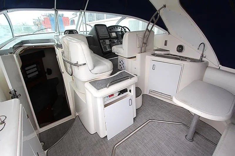 Slide: The Image of Interior of 2007 Cruisers 420 yacht with helm, seating, and kitchenette. - 7