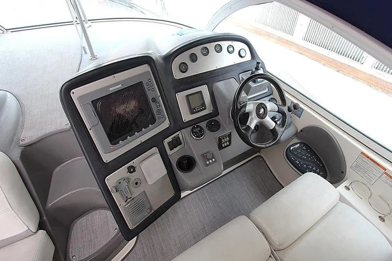 Slide: The Image of Cockpit of 2007 Cruisers 420 yacht with steering wheel and navigation controls. - 9