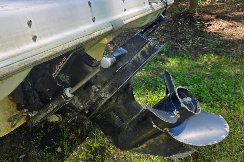 Slide: The Image of Outboard motor of 2001 Smoker Craft 2310 Commander boat, showing propeller and drive mechanism. - 10