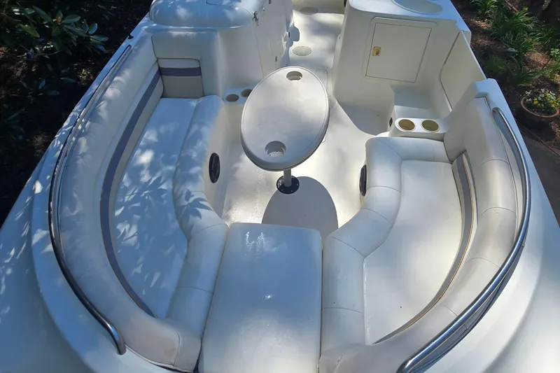 Slide: The Image of 2001 Smoker Craft 2310 Commander boat interior with white seating and oval table. - 11