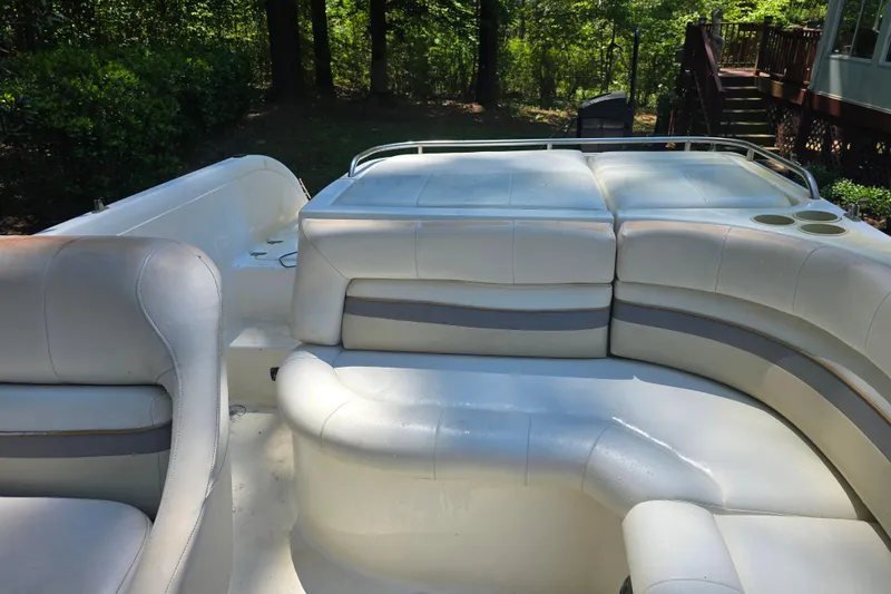 Slide: The Image of 2001 Smoker Craft 2310 Commander boat interior with white cushioned seating and cup holders. - 20