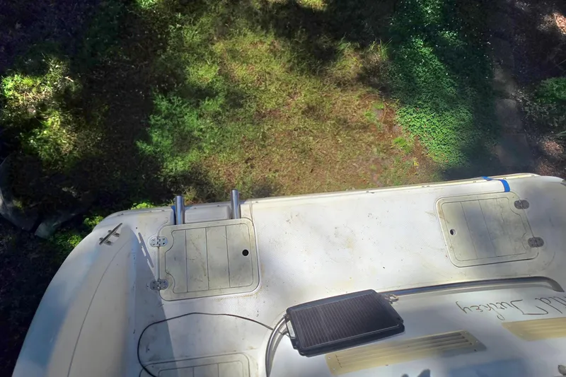 Slide: The Image of Top view of a 2001 Smoker Craft 2310 Commander boat deck in sunlight. - 22