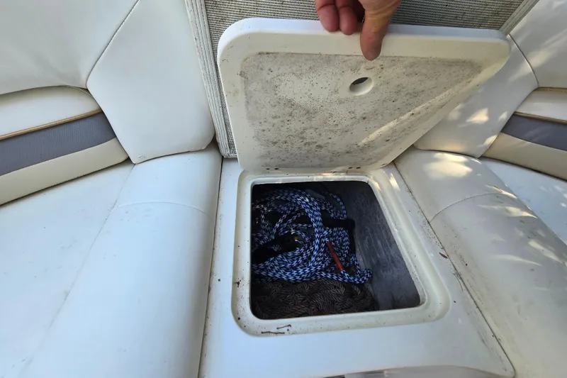 Slide: The Image of Storage compartment on a 2001 Smoker Craft 2310 Commander boat, containing ropes. - 24