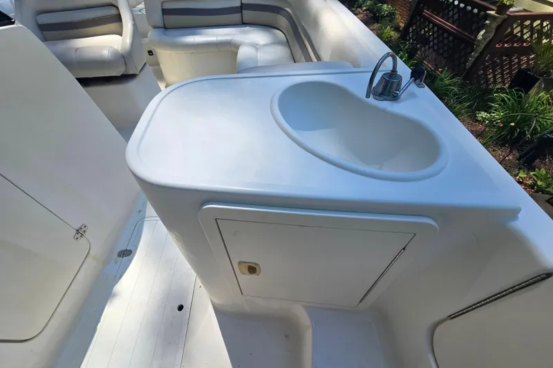 Slide: The Image of 2001 Smoker Craft 2310 Commander boat interior with sink and seating area. - 25