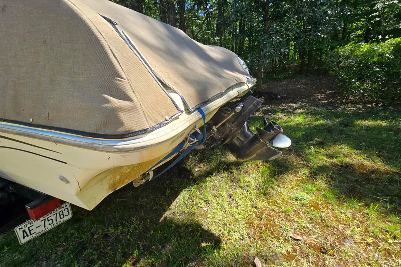 Slide: The Image of 2001 Smoker Craft 2310 Commander boat with cover, parked on grass. - 5