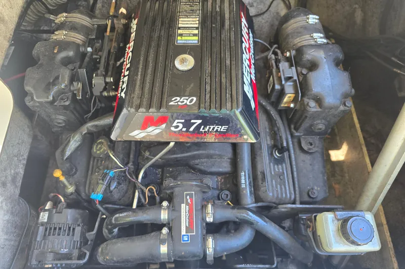 Slide: The Image of Engine of a 2001 Smoker Craft 2310 Commander boat, featuring a 5.7-liter Mercury motor. - 9