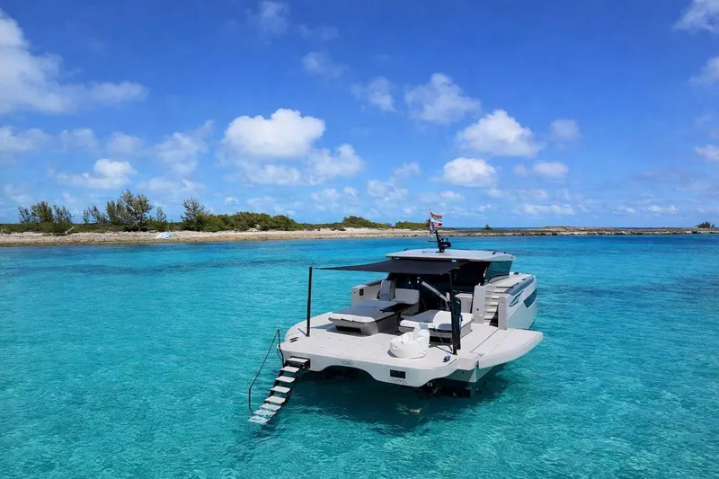 Slide: The Image of Luxury Sunreef Ultima 2026 yacht anchored in clear turquoise waters, under a bright blue sky. - 3