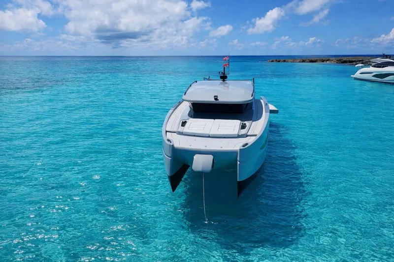 Slide: The Image of Luxury Sunreef Ultima 2026 yacht anchored in crystal-clear turquoise waters. - 5