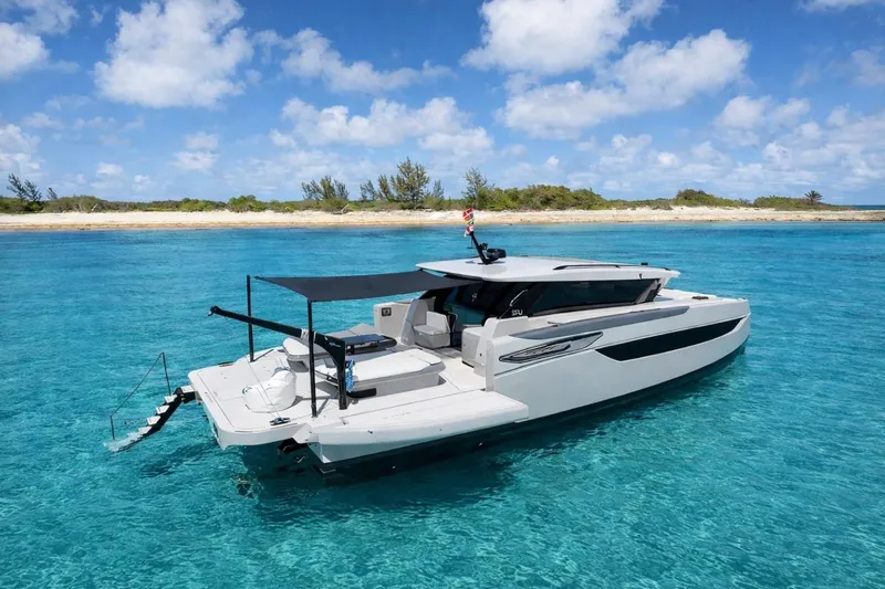 Slide: The Image of Luxury Sunreef Ultima 2026 yacht anchored in clear turquoise waters near a sandy island. - 8