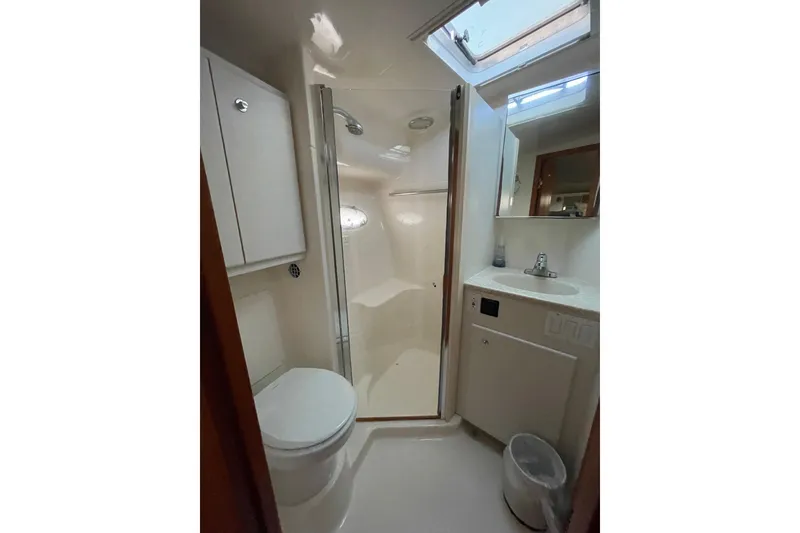 Slide: The Image of Bathroom interior of 2002 Tiara Yachts 4100 Open, featuring shower, toilet, and sink. - 4