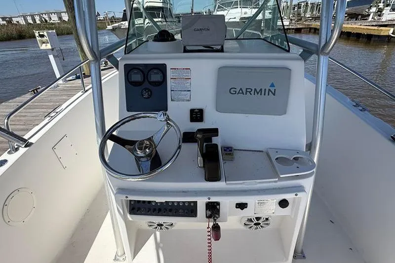 Slide: The Image of 2003 Robalo R230 Center Console boat dashboard with Garmin navigation system. - 11