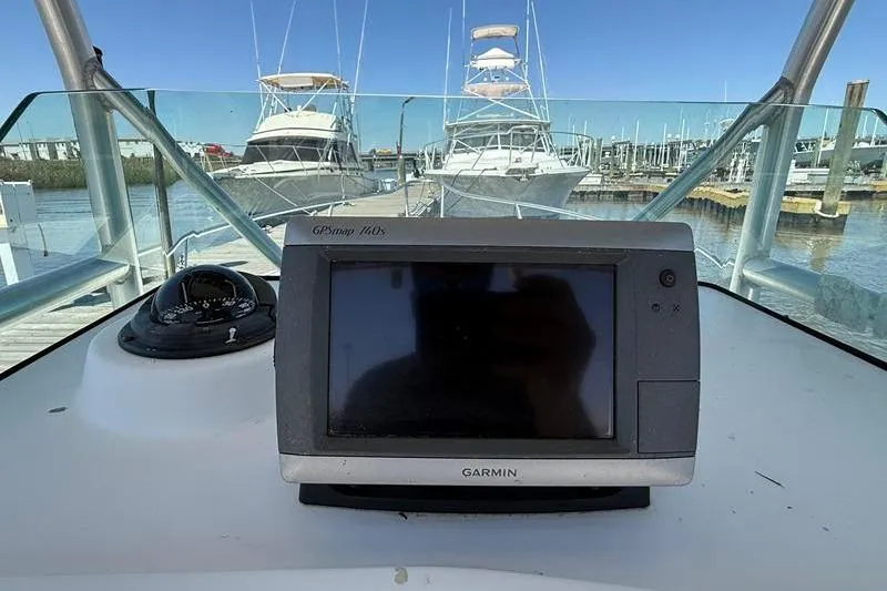 Slide: The Image of Garmin GPS on 2003 Robalo R230 Center Console boat, docked with yachts in background. - 16