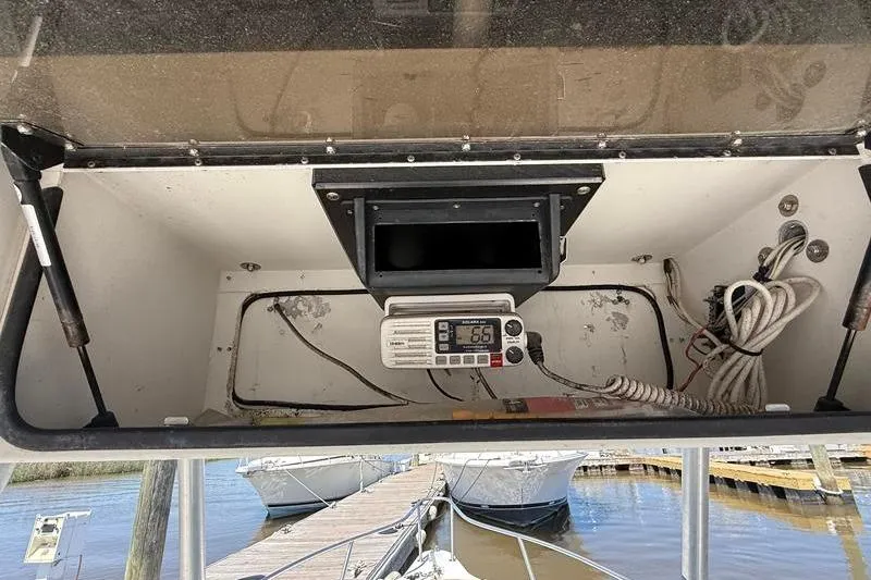 Slide: The Image of 2003 Robalo R230 Center Console boat dashboard with radio and wiring. - 20