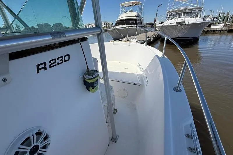 Slide: The Image of 2003 Robalo R230 Center Console boat docked at marina. - 22