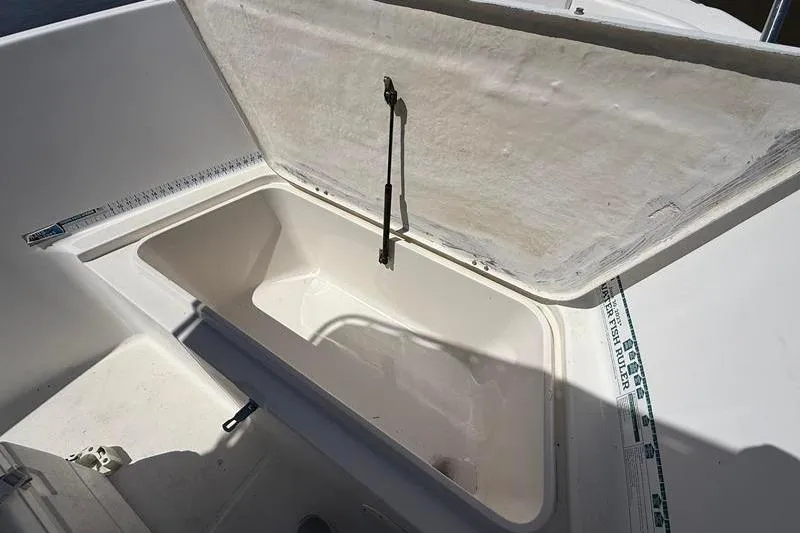 Slide: The Image of Open storage compartment on a 2003 Robalo R230 Center Console boat. - 24