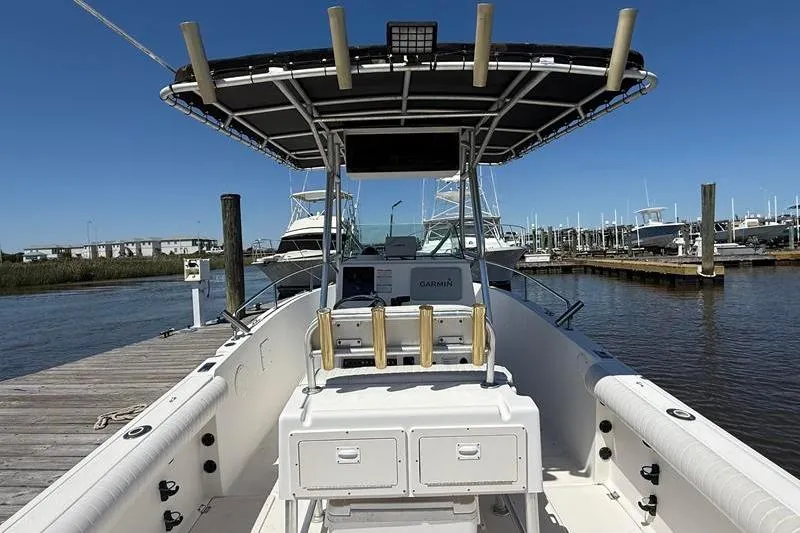 Slide: The Image of 2003 Robalo R230 Center Console boat docked at marina under clear blue sky. - 5