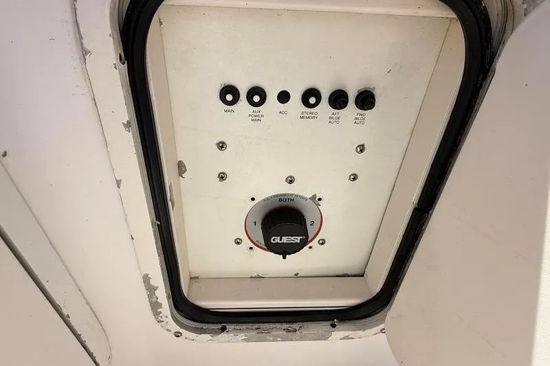 Slide: The Image of Control panel of a 2003 Robalo R230 Center Console boat with switches and a dial. - 8