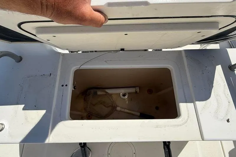 Slide: The Image of Open storage compartment on 2003 Robalo R230 Center Console boat. - 9