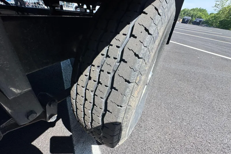 Slide: The Image of Close-up of a worn tire on a 2021 Crest RS250 vehicle in a parking lot. - 10