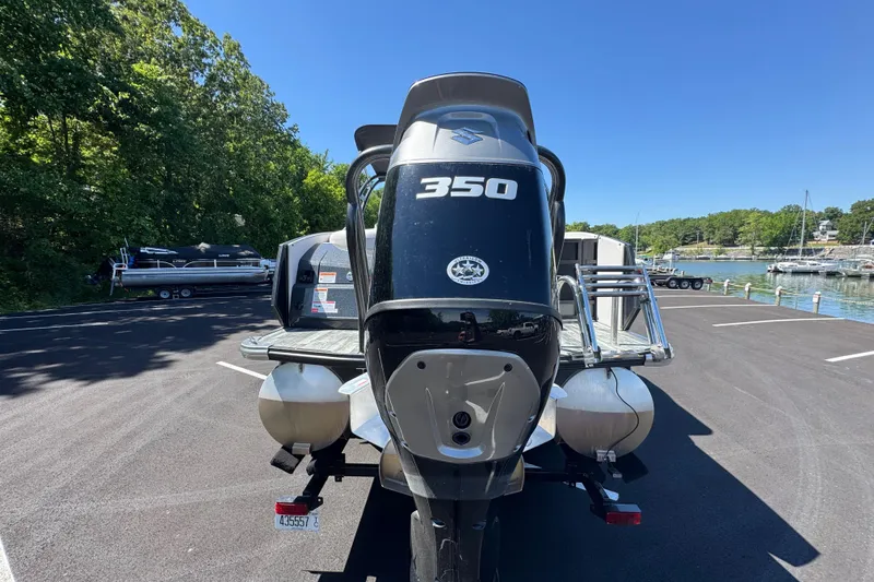 Slide: The Image of 2021 Crest RS250 boat with powerful 350 engine, parked near a scenic lake. - 14