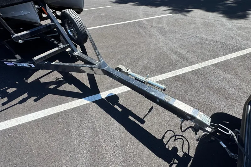 Slide: The Image of Trailer hitch of a 2021 Crest RS250 boat in a parking lot. - 21