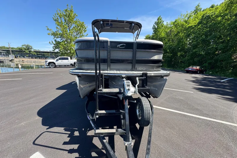 Slide: The Image of 2021 Crest RS250 pontoon boat on trailer in sunny parking lot. - 22