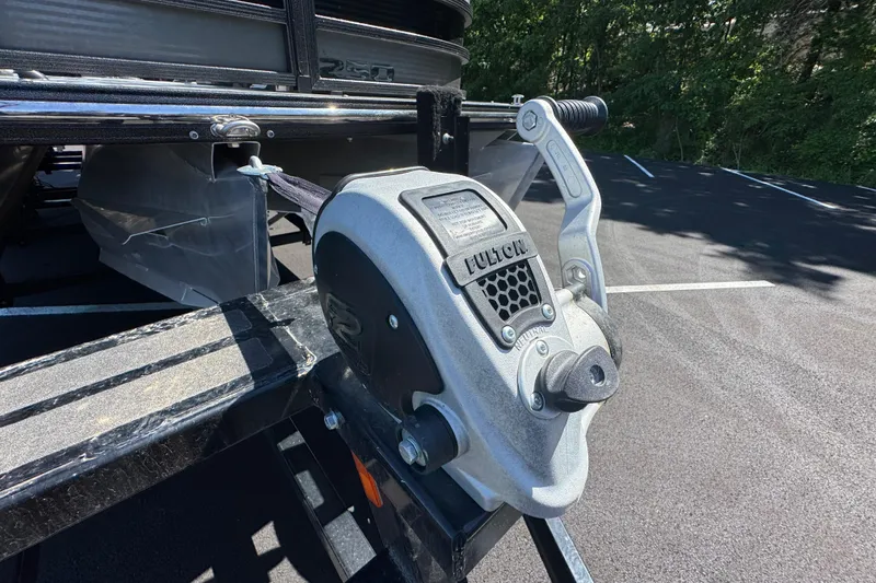 Slide: The Image of Close-up of a 2021 Crest RS250 boat trailer winch in a parking lot. - 23