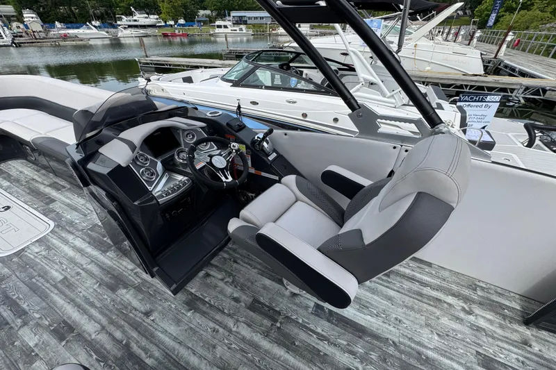 Slide: The Image of 2021 Crest RS250 boat interior with modern helm and seating at marina. - 26