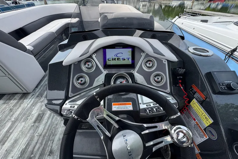 Slide: The Image of Dashboard of a 2021 Crest RS250 boat with steering wheel and control panel. - 28