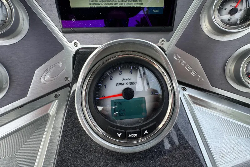 Slide: The Image of Dashboard of a 2021 Crest RS250 boat showing RPM gauge and controls. - 30
