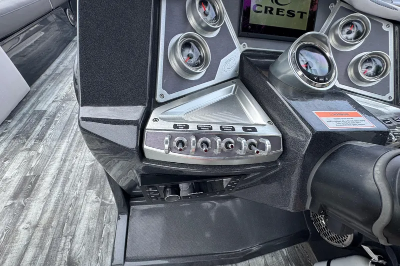 Slide: The Image of Control panel of a 2021 Crest RS250 boat with gauges and switches. - 31
