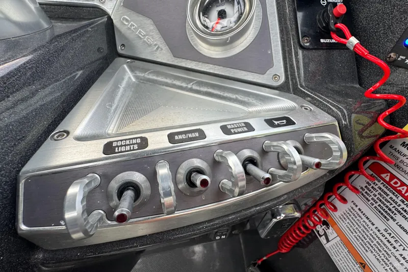 Slide: The Image of Control panel of a 2021 Crest RS250 boat with labeled switches and gauges. - 32