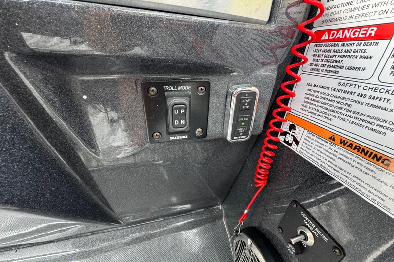 Slide: The Image of Control panel of a 2021 Crest RS250 boat with safety warnings and Suzuki troll mode. - 33
