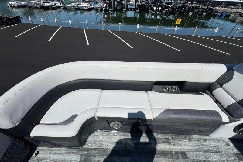 Slide: The Image of Luxurious seating on 2021 Crest RS250 boat, dockside view with marina background. - 40