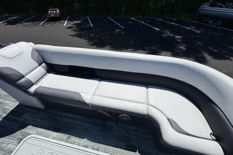 Slide: The Image of 2021 Crest RS250 boat interior with sleek, modern seating in a parking lot setting. - 41