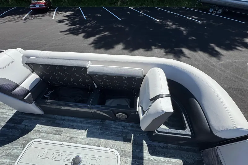 Slide: The Image of 2021 Crest RS250 boat interior with open storage compartments and cushioned seating. - 42