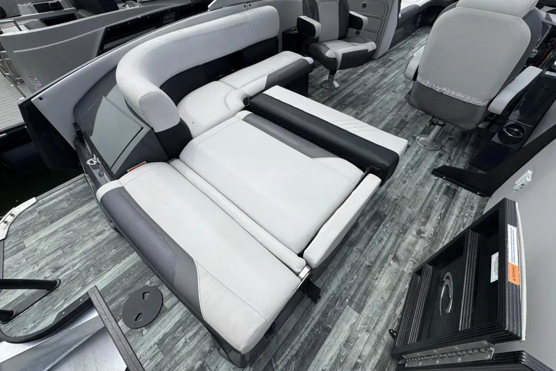 Slide: The Image of 2021 Crest RS250 boat interior with gray seating and wood-style flooring. - 46
