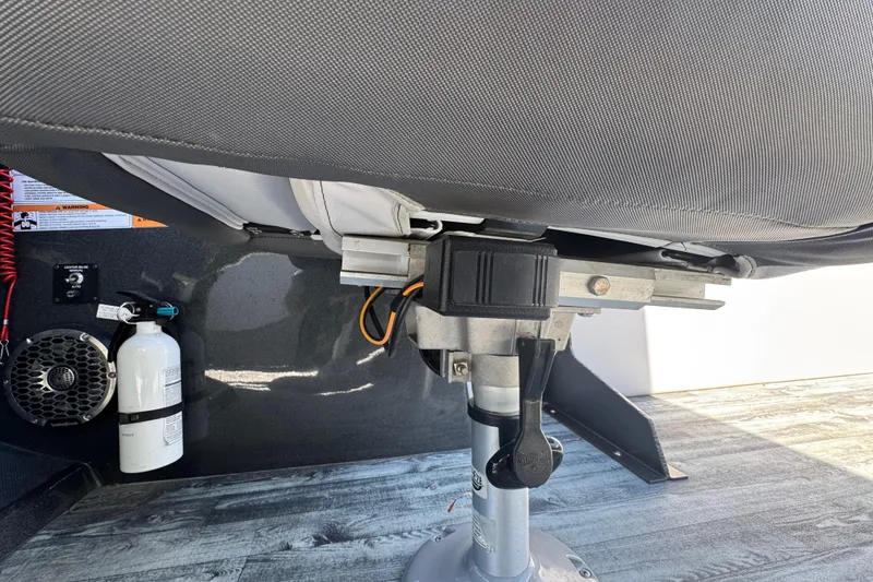 Slide: The Image of Interior of 2021 Crest RS250 boat showing seat base, fire extinguisher, and speaker. - 49
