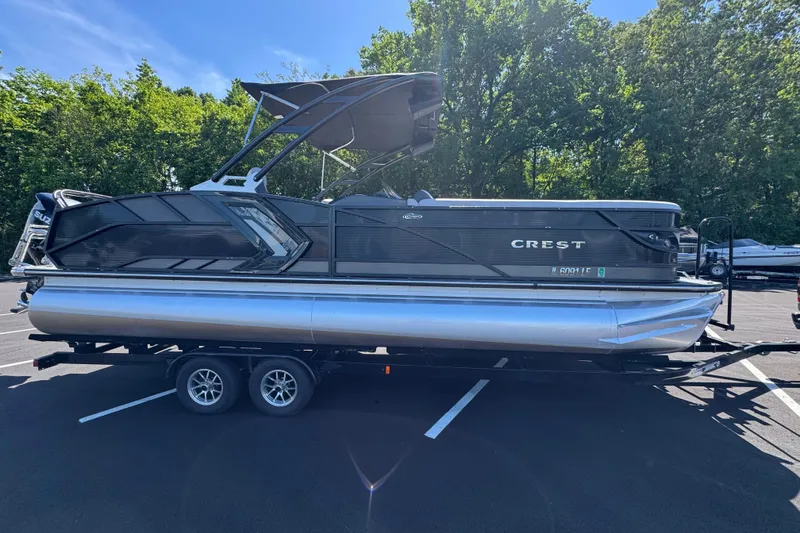 Slide: The Image of 2021 Crest RS250 pontoon boat on trailer, parked in sunny outdoor setting. - 8