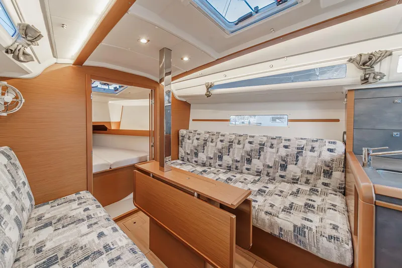 Slide: The Image of Interior of 2022 Jeanneau Sun Odyssey 349 sailboat, featuring cozy seating and modern design. - 15