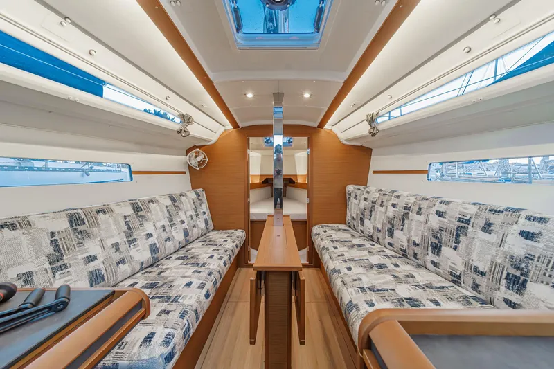 Slide: The Image of Interior of 2022 Jeanneau Sun Odyssey 349 sailboat with modern seating and wooden accents. - 19