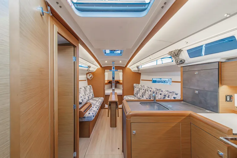 Slide: The Image of Interior of 2022 Jeanneau Sun Odyssey 349 sailboat, featuring modern wood finish and skylights. - 21