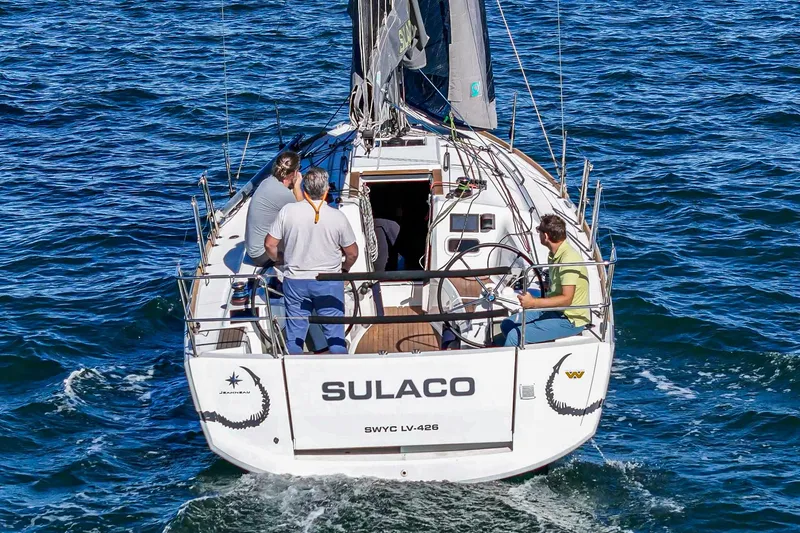 Slide: The Image of 2022 Jeanneau Sun Odyssey 349 sailboat "Sulaco" on open water with crew onboard. - 4