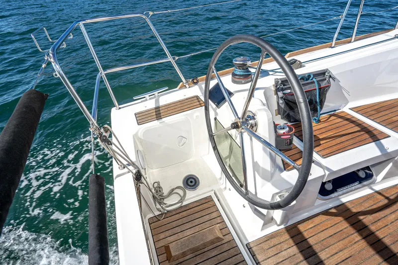 Slide: The Image of Cockpit of 2022 Jeanneau Sun Odyssey 349 sailboat with wooden deck and steering wheel. - 46