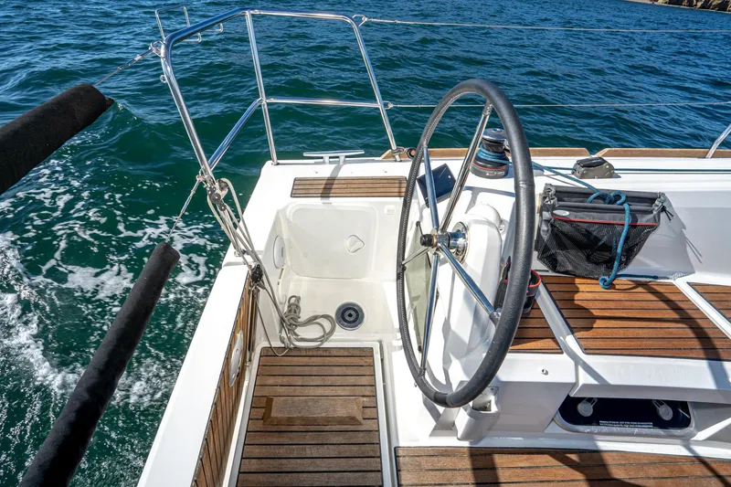 Slide: The Image of 2022 Jeanneau Sun Odyssey 349 sailboat cockpit with steering wheel and teak flooring. - 47